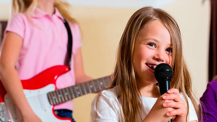 a girl singing into a microphone