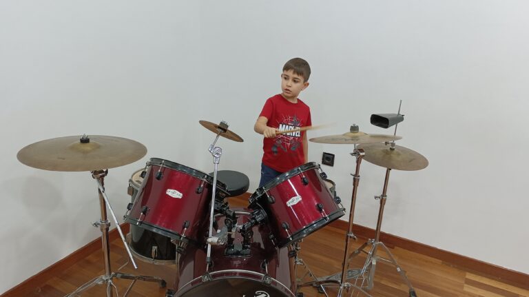 a boy playing a drum set