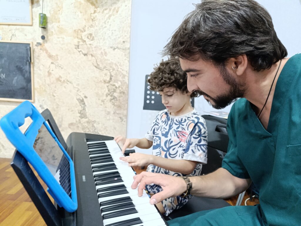 a man and boy playing piano