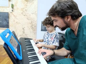 a man and boy playing piano