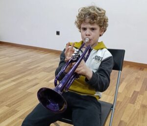 a boy playing a trumpet