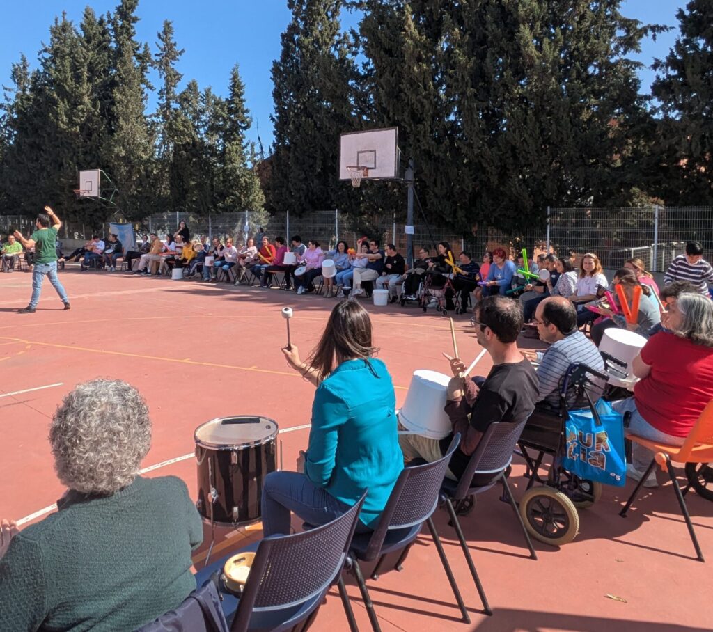 a group of people sitting on chairs on a court